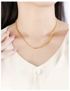 Minimalist gold snake bone chain necklace for women, stylish stackable dainty jewelry piece.