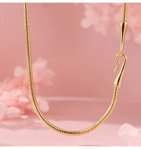 Gold snake chain necklace detail, minimalist metal choker for women stackable jewelry.