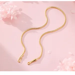 Gold snake chain detail shot, minimalist style jewelry close up for daily wear or stacking.