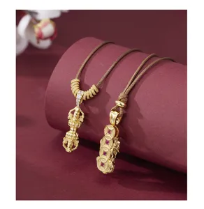 Close-up detail of Chinese style gold-plated pendant necklace with intricate retro design.