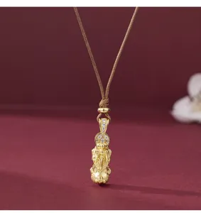 Closeup detail of Chinese style gold plated sterling silver pendant necklace with sparkling stones.