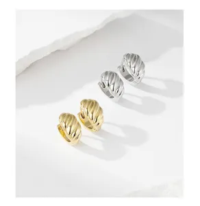 Detailed view of trendy geometric gold and silver copper hoop earrings, minimalist chic style.