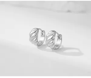 Minimalist copper hoop earrings featuring a trendy geometric twisted design for daily wear.