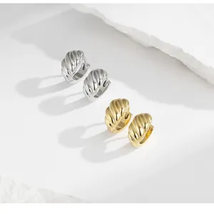 Chunky twisted croissant hoop earrings in gold and silver, geometric minimalist jewelry.
