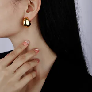 Chunky gold C-shape hoop earrings for women, minimalist polished metallic statement jewelry
