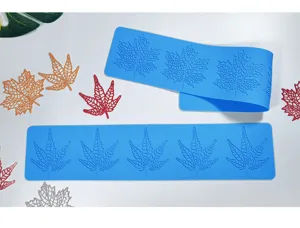 Close-up detail of blue silicone leaf lace mold and colorful maple leaf cake decor.