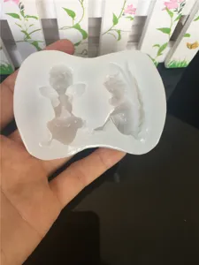 Silicone mold for DIY epoxy resin and clay crafts featuring cute sleeping baby and angel wings.