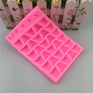 Pink silicone mold detail showing letter and flower embossed cavity design for baking crafts.