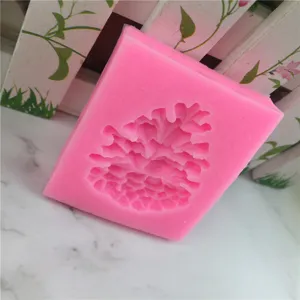 Pink silicone pinecone mold for cake decorating, chocolate fondant baking tool detail view.