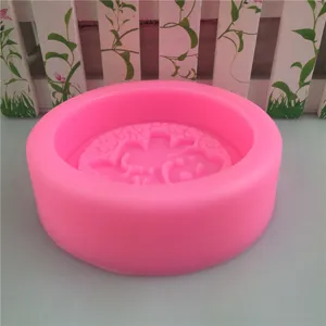 Pink silicone mold for handmade soap, candles, and baking with a cute character design.