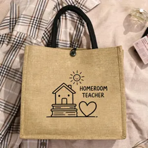 Detailed view of the cute teacher jute tote bag with clean line art and sturdy black handles.