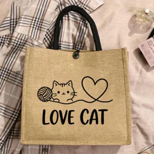 Natural jute tote bag with cute cat line art and English letter print for daily shopping.