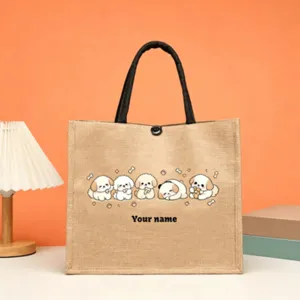 Customizable jute tote bag featuring cute puppy graphic and personalized name text detail.