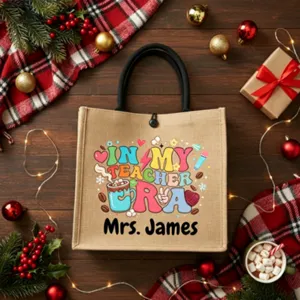 Close-up detail of a personalized jute tote bag featuring a festive teacher era print design.