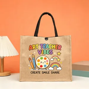 Art teacher jute tote bag with cute cartoon rainbow design, durable reusable shopping bag.