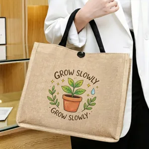 Detailed shot of the natural jute tote bag featuring plant print and durable handles for daily use.