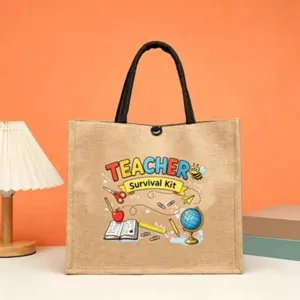 Close-up detail of the teacher theme jute tote bag with cute school icons and handle.