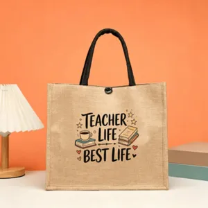 Jute tote bag featuring teacher life print, spacious design with black handles for daily use.
