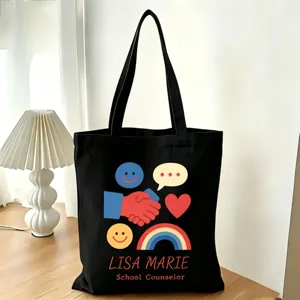 Schwarze Segeltuchtasche mit personalisiertem Regenbogen-Smiley-Druck und Lehrernamen-Text.