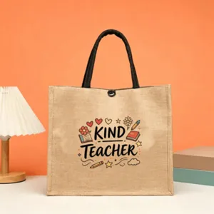 Detailed view of jute tote bag featuring teacher print, black handles and natural linen fabric.