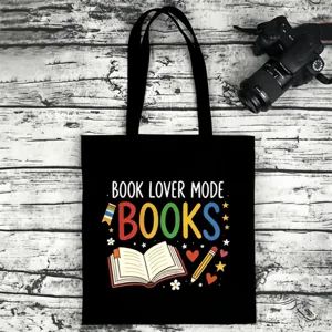 Black canvas tote bag with book lover print, durable casual shoulder bag for daily use.