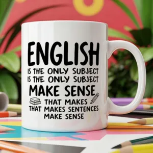 White ceramic coffee mug detail with English typography print and cute pencil and book graphics.
