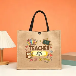 Close-up detail of the teacher theme jute tote bag featuring cute owl print and black handles.
