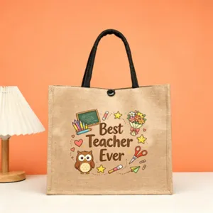 Close-up detail of the jute tote bag featuring cute teacher print and sturdy black handles.