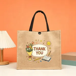 Detail shot of the burlap tote bag with teacher appreciation print, lamp and books setup.