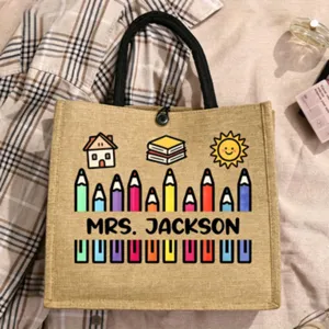 Customizable teacher jute tote bag featuring cute cartoon pencil and book print details.