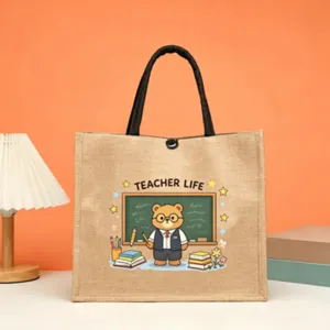 Close-up detail of the cute teacher cartoon print jute tote bag on a warm orange background.