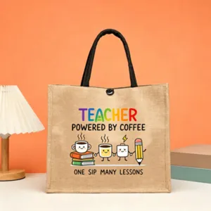 Teacher themed jute tote bag with cute coffee and book print, durable canvas handles.