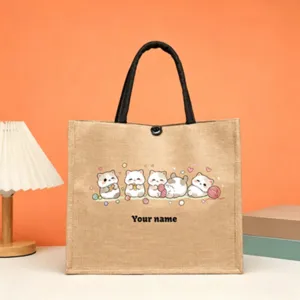 Detail view of customizable jute tote bag featuring cute cat prints and text area.