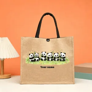 Customizable jute tote bag featuring cute pandas and bamboo print with black handles.