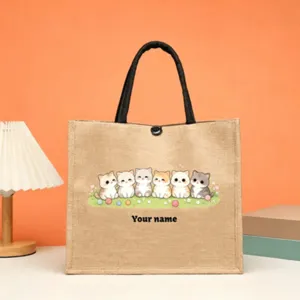 Detailed view of the custom jute tote bag featuring cute cats illustration and personalized name text.