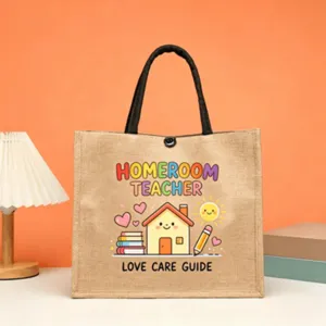 Detailed view of the teacher jute tote bag featuring cute cartoon school design and sturdy handles.
