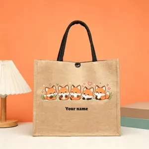 Detailed close-up view of custom jute tote bag featuring cute cartoon foxes and sturdy handle.