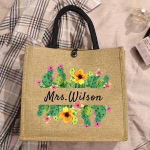Personalized floral jute tote bag, custom name plant print canvas handbag detail view.