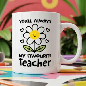 Detailed close-up of a white ceramic coffee mug featuring a cute flower and teacher quote.