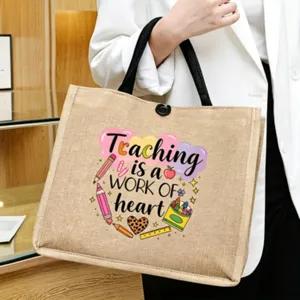 Close-up of the teacher quote print and durable jute fabric on this stylish tote bag detail.
