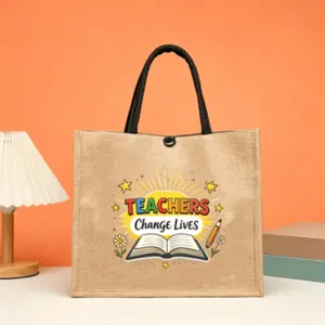 Burlap tote bag for teachers with black handles and motivational English print design.
