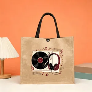 Detail view of the retro music print jute tote bag with black handles and snap closure.