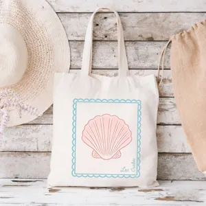 Nahaufnahme des beige-farbenen Leinentragetuchs mit Muscheldruck und blauem Randdetail.