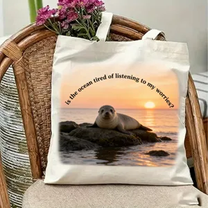 Canvas tote bag with sunset seal print, casual shoulder bag for travel and daily use.