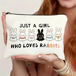 Close-up detail of white canvas makeup pouch featuring cute rabbit prints and sweet slogan text.