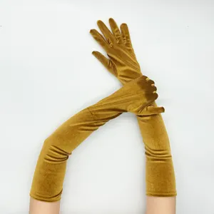 Long golden velvet gloves detail shot, perfect for winter stage performances and retro parties.