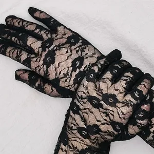 Close-up detail of elegant black floral lace gloves, sheer and breathable design for women.