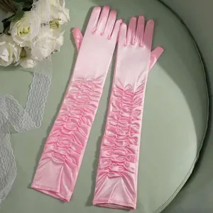 Detailed view of elegant pink satin ruffled long gloves, perfect for bridal wedding events.