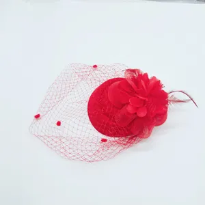 Close-up of the red mesh fascinator hat featuring exquisite feather and vintage floral details.