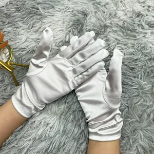 Close-up detail of elegant shiny satin gloves, smooth fabric texture for wedding party wear.